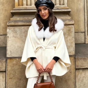Elegant cream faux fur cloak coat with plush collar and tie-waist in a street style look