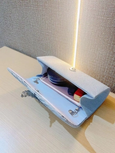 Internal view of silver sequin clutch showing space for phone, lipstick and makeup
