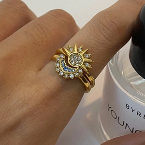 Gold celestial sun and moon stacking ring set with blue crystals and white zircons