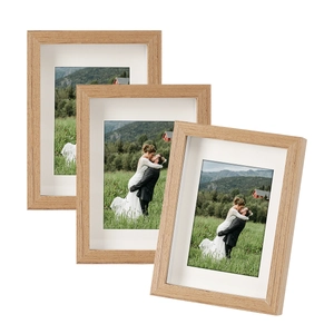 Set of three solid wood picture frames with white mats and natural grain finish
