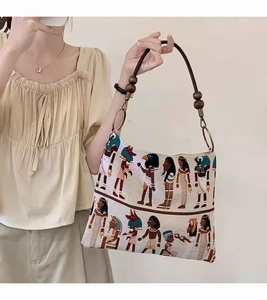 Close-up of retro pharaoh jacquard canvas tote with decorative wooden bead handle