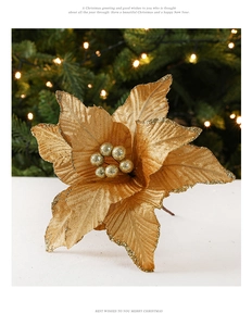 Close-up of golden artificial poinsettia with glitter edges and fabric texture detail