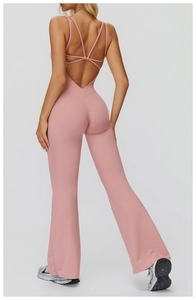 Detailed back view of pink backless yoga jumpsuit with crisscross straps and flare legs