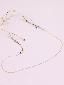 Detail of colorful evil eye charms on a gold-plated metal glasses chain with silicone loops