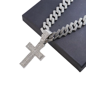Hip hop silver iced out cross pendant with cubic zirconia rhinestones on a chunky Cuban chain