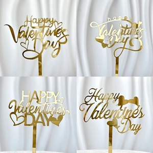 Four styles of gold mirror acrylic Happy Valentine's Day cake toppers on white fabric