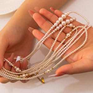 Elegant multi-layer pearl necklace with 18K gold-plated beads shown on model hands
