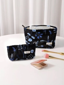 Linen makeup bag set with blue floral embroidery and white minimalist logo tag