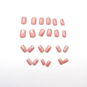 Short square soft pink press-on nails with silver glitter gradient and snowflake patterns