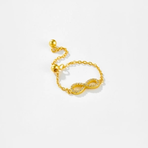 Macro detail of gold S925 sterling silver infinity ring with adjustable pull chain