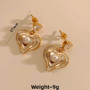 Detail of 27mm 3D heart earrings featuring zircon accents and white pearls in gold plating