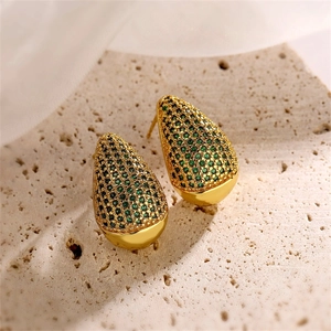 Macro detail of gold teardrop earrings featuring micro-pave green zircon stones