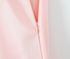 Detail of pink French dress showing seamless invisible zipper and twill fabric texture