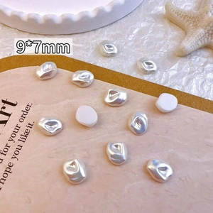 Macro detail of 9x7mm baroque irregular resin pearls for DIY nail art and jewelry