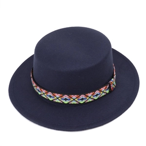 Close-up of navy wool fedora hat featuring a colorful geometric woven decorative band