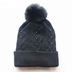Winter knit beanie for women with warm fleece lining, faux fur pompom, and silver beads