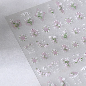 Floral nail art stickers with white daisies and purple grid patterns for manicure decor