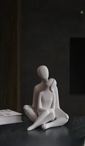 Detail of white matte ceramic couple sculpture with smooth lines and minimalist art style