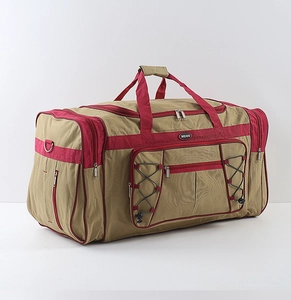 Detail view of khaki waterproof travel bag with reinforced red straps and multi-pockets
