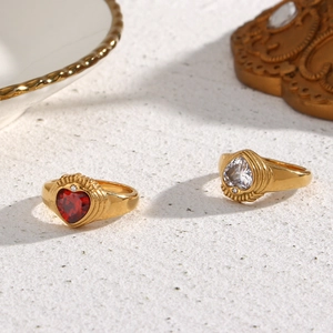 Macro detail of crown-style rings featuring red and white heart-shaped zircons