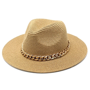 Close-up of a khaki straw fedora hat featuring a stylish chunky gold chain decoration