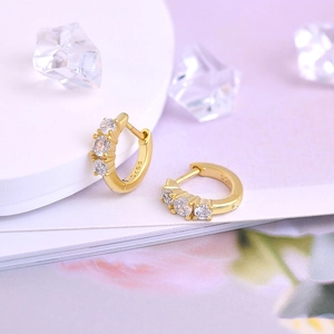 Macro view of gold plated S925 sterling silver hoop earrings with clear cubic zirconia
