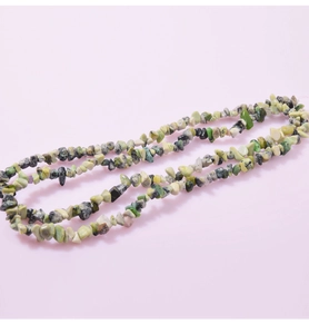 Close-up of natural irregular green yellow and black crystal stone beads for jewelry DIY