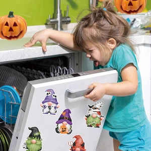 Halloween gnome magnets on a dishwasher with a child in a decorated kitchen