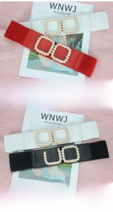 Detail view of elastic waist belt featuring luxury faux pearl square double buckles