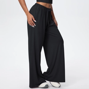 Detail of high-waist black wide-leg sports pants featuring adjustable drawstring waist