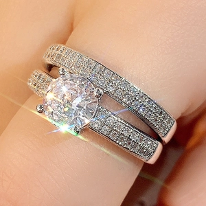 Macro detail of silver ring set with large round centerpiece and micro-pave diamond accents