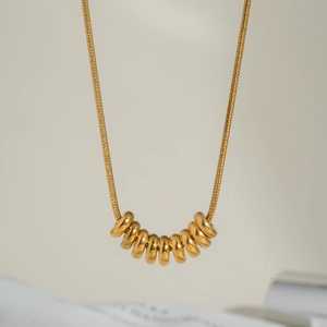 Elegant gold beaded snake chain necklace with high-polish metallic pendant rings