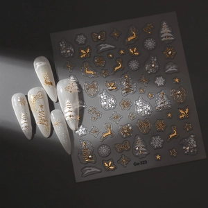 Macro detail of Christmas nail art stickers featuring gold reindeer and snowflake patterns