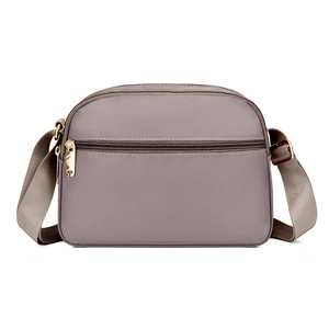 Women's lightweight nylon crossbody shoulder bag in soft mauve with golden metal zippers