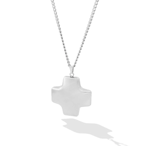 Macro shot of silver cross pendant with a thin link chain and sharp artistic shadows