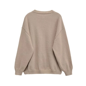 Women's loose knit round neck sweater in oatmeal color with ribbed details and drop shoulders