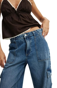 Detailed view of high-waist denim cargo pants with large side pockets and washed finish