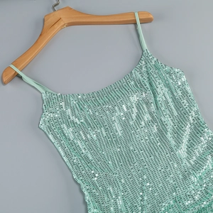 Detail of mint green sequin dress showing thin straps and intricate embroidery work