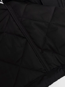 Detailansicht der schwarzen Rautensteppung und präzisen Nähte der gesteppten Jacke