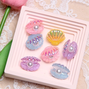 Colorful resin pearl shell charms for DIY jewelry making displayed on pink tray