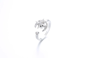 Detail of silver spinner ring featuring sparkling zircon moon and star with open design