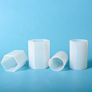Detailed view of four translucent cylindrical and hexagonal silicone resin casting molds