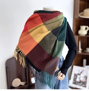 Close-up of colorful geometric plaid scarf with fringe detail and soft cashmere-like texture
