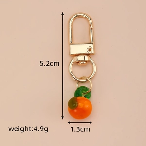 Detailed size view of an orange fruit glass keychain with gold hardware and dimensions