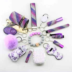 Purple 14-piece self-defense keychain set with rhinestone wristlet and marble accessories