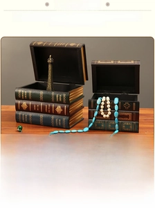 Detail view of European vintage faux book storage boxes with golden hot stamping on wood