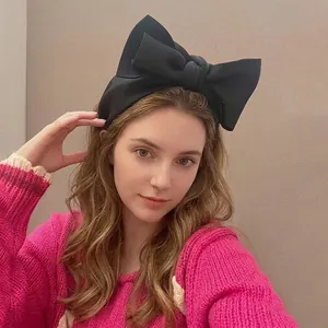 Oversized black matte fabric bow headband for women, stylish high-crown hair accessory