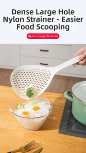 Action shot of long-handled nylon skimmer straining noodles over a kitchen bowl