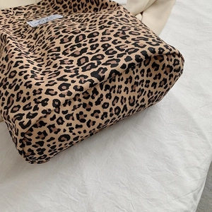 Detail of leopard print canvas tote bag showing base stitching and fabric texture
