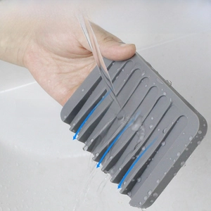 Grey silicone soap holder with self-draining waterfall grooves for easy water runoff